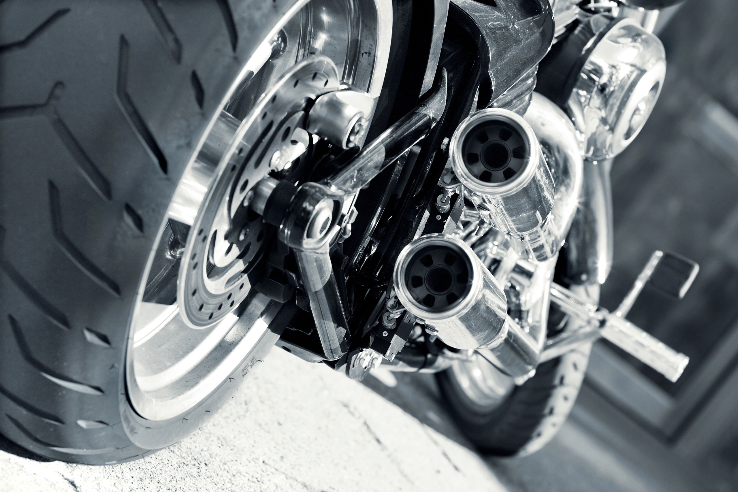 Close-up of a motorcycle exhaust and mechanical detail
