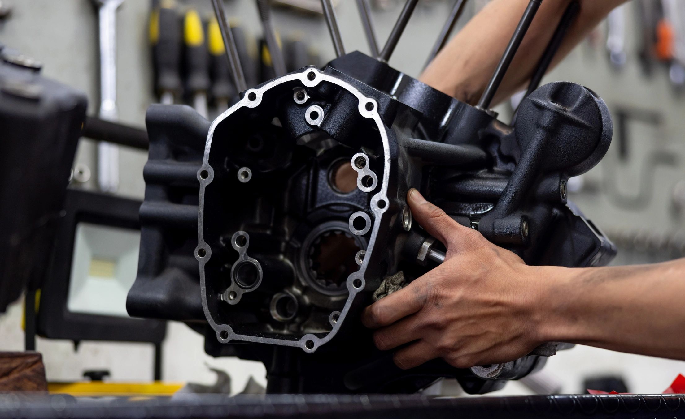Mechanic repairing a motorcycle engine