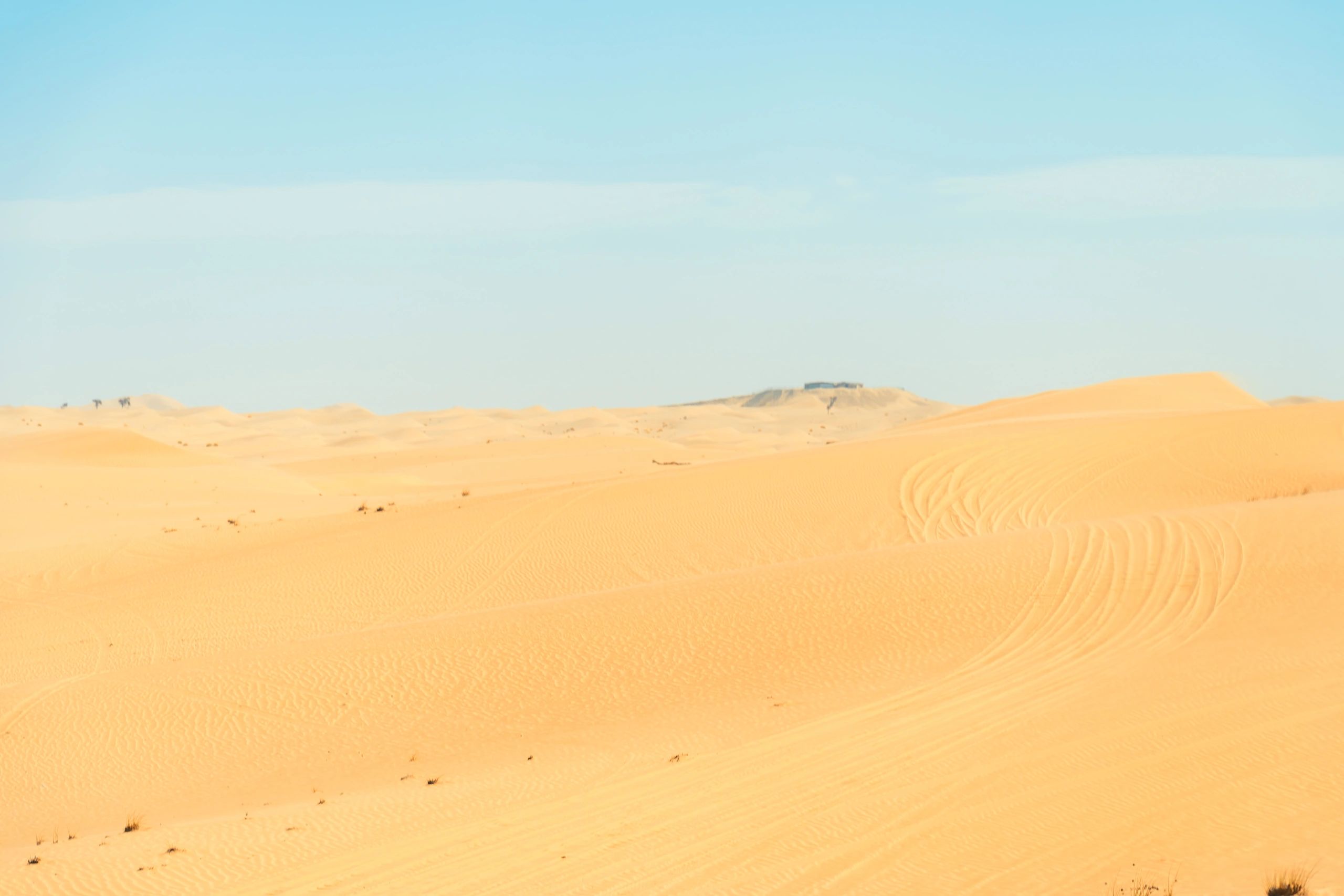 Adventure motorcycle riding through Dubai desert terrain