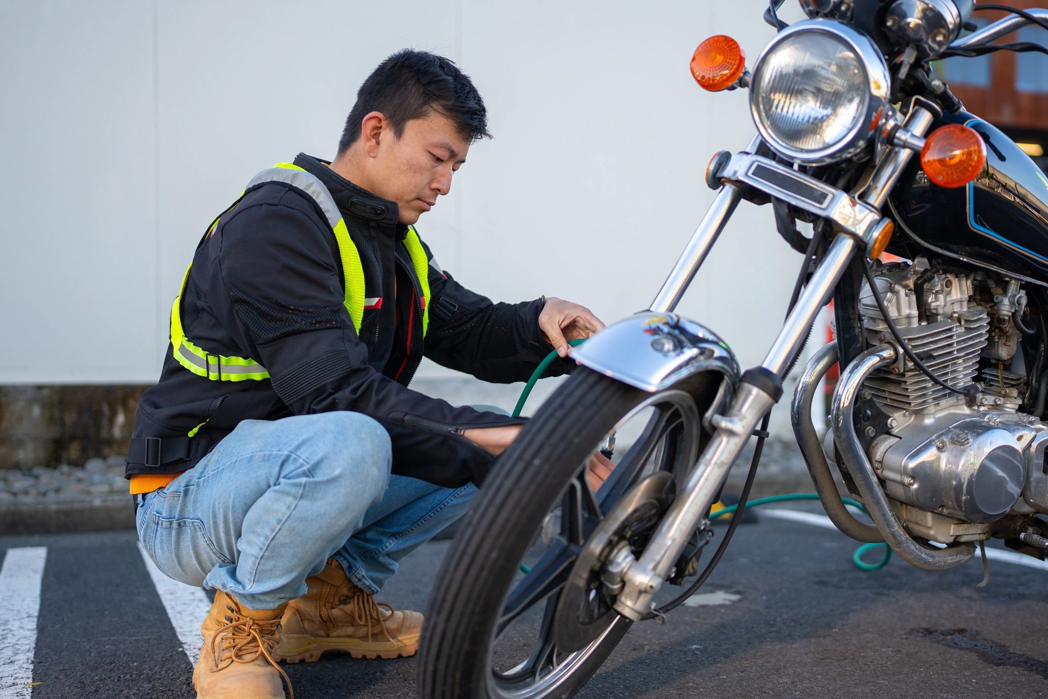 Mechanic checking motorcycle tyre pressure